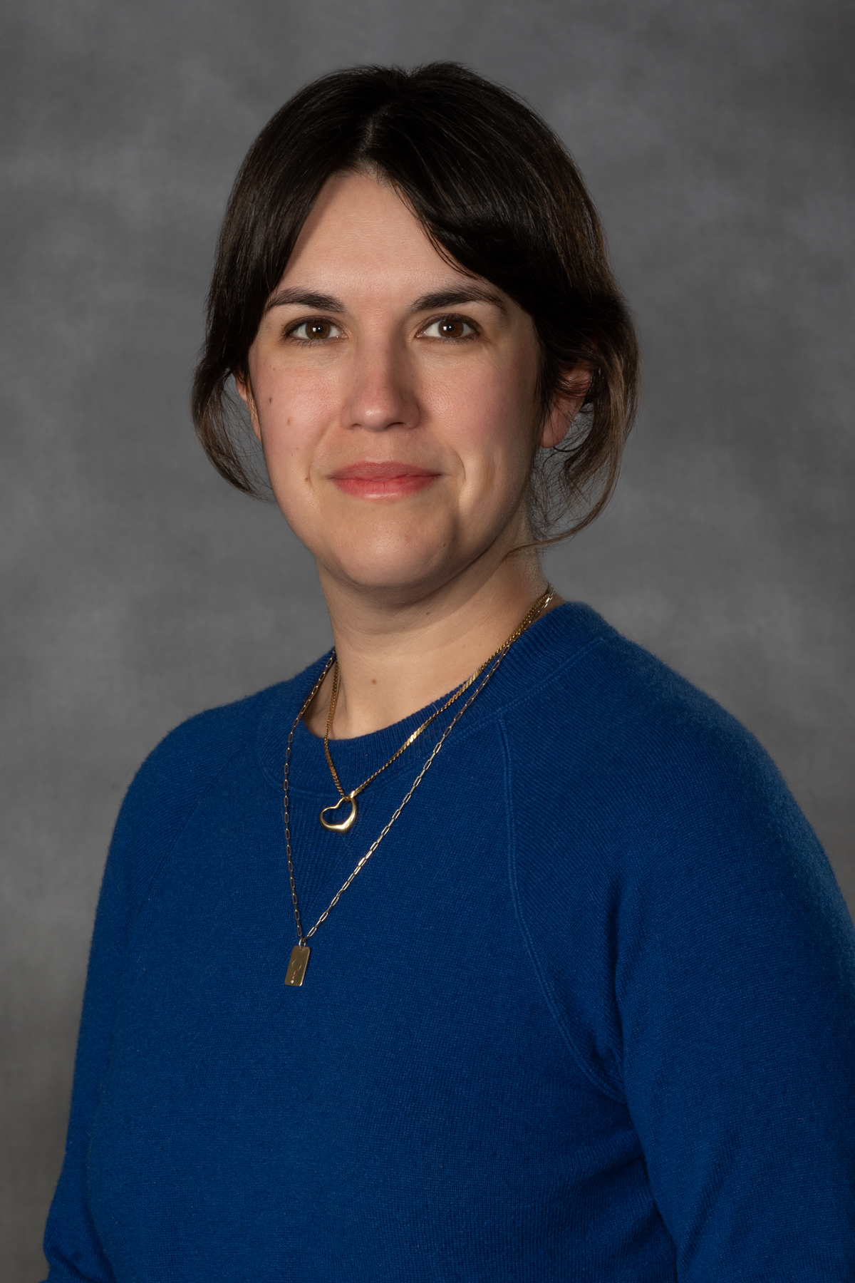 Headshot of Sara Roan from the shoulders up smiling.